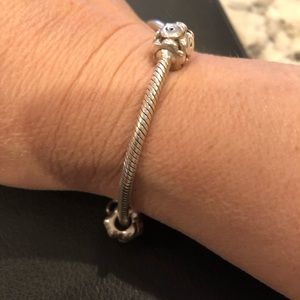 Genuine Pandora charm bracelet. 7 “ with 2 silver charms on it.